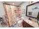 Well-lit bathroom featuring tiled shower, stylish vanity, and decorative mirror for a fresh look at 115 King Arthur Dr, Franklin, IN 46131