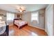 This cozy bedroom features wood floors, a ceiling fan, and a closet for ample storage at 115 King Arthur Dr, Franklin, IN 46131