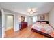 Comfortable bedroom with hardwood floors, ceiling fan, and ample natural light at 115 King Arthur Dr, Franklin, IN 46131