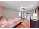 Serene bedroom featuring hardwood floors, ceiling fan, closet, and natural light at 115 King Arthur Dr, Franklin, IN 46131