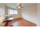 A simple bedroom has wood floors, closet, desk, and a ceiling fan at 115 King Arthur Dr, Franklin, IN 46131