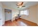 A simple bedroom has wood floors, closet, desk, and a ceiling fan at 115 King Arthur Dr, Franklin, IN 46131