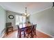 Inviting dining room featuring a large wood table and bay window for ample natural light at 115 King Arthur Dr, Franklin, IN 46131