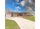 Charming single-story home featuring a brick facade, attached garage, and well-manicured front yard at 115 King Arthur Dr, Franklin, IN 46131