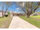 Inviting single-story home with a brick facade, long driveway, and mature trees in the front yard at 115 King Arthur Dr, Franklin, IN 46131