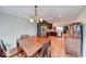 Open-concept kitchen with modern appliances, wooden dining table, and seamless access to the living area at 115 King Arthur Dr, Franklin, IN 46131