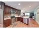 Modern kitchen featuring dark wood cabinets, stainless steel appliances, and an open design at 115 King Arthur Dr, Franklin, IN 46131