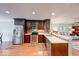 Well-appointed kitchen featuring dark wood cabinets, stainless steel appliances, and ample counter space at 115 King Arthur Dr, Franklin, IN 46131