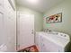 Functional laundry room with washer, dryer, storage closet, and neutral color scheme at 115 King Arthur Dr, Franklin, IN 46131