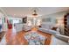 Open-concept living room with hardwood floors and seamless transition to the kitchen and dining areas at 115 King Arthur Dr, Franklin, IN 46131