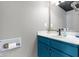 Bathroom with a blue vanity, modern faucet, and unique toilet paper holder at 11741 Langham Crescent Ct, Fishers, IN 46037