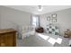 Neutral bedroom with natural light from window, a crib, and neutral-colored decor at 11741 Langham Crescent Ct, Fishers, IN 46037