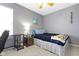 Cozy bedroom with a desk, a comfortable bed, and a nightstand with a lamp at 11741 Langham Crescent Ct, Fishers, IN 46037