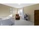 Bedroom with a crib, recliner, neutral walls, and plenty of natural light at 11741 Langham Crescent Ct, Fishers, IN 46037