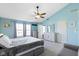 Large bedroom with a ceiling fan, seating and several windows for natural light at 11741 Langham Crescent Ct, Fishers, IN 46037