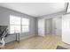 Bedroom featuring a large window, light gray walls, and light wood flooring at 11741 Langham Crescent Ct, Fishers, IN 46037