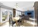 Open floor plan connects dining room with a butcher block island, kitchen, and cozy living space at 11741 Langham Crescent Ct, Fishers, IN 46037