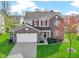 Charming two-story home featuring a well-maintained lawn, brick accents, and attractive red shutters at 11741 Langham Crescent Ct, Fishers, IN 46037