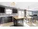 Bright kitchen with an island, stainless steel dishwasher and plentiful cabinets near dining table and living room at 11741 Langham Crescent Ct, Fishers, IN 46037