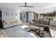 Spacious living room with multiple seating areas, hardwood flooring and a view of the adjacent kitchen at 11741 Langham Crescent Ct, Fishers, IN 46037