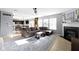 Bright and airy living room open to the kitchen and fireplace, featuring plush seating and ample natural light at 11741 Langham Crescent Ct, Fishers, IN 46037