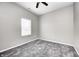 Cozy bedroom with a window, gray walls, and soft, gray carpeting for ultimate comfort at 11975 Civic Cir, Mooresville, IN 46158