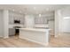 Modern kitchen boasting gray cabinets, stainless steel appliances, and a large center island at 12009 Jeff Ct, Noblesville, IN 46060