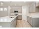 Modern kitchen featuring a large island with a sink, stainless steel appliances, and gray cabinets at 12009 Jeff Ct, Noblesville, IN 46060