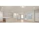 Open-concept living space with a view of the kitchen, stairs, and backyard access at 12009 Jeff Ct, Noblesville, IN 46060