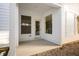 Covered patio with white pillars, neutral stained concrete, and rock landscaping at 12009 Jeff Ct, Noblesville, IN 46060