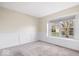 Cozy bedroom with neutral carpet, base-board molding, white wainscoting, and natural light from a window at 12527 Saksons Blvd, Fishers, IN 46038