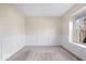 Cozy bedroom with neutral carpet, base-board molding, white wainscoting, and natural light from a window at 12527 Saksons Blvd, Fishers, IN 46038