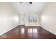 Inviting living room with hardwood floors, natural light, and a front door with decorative glass at 12527 Saksons Blvd, Fishers, IN 46038