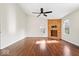Bright living room featuring a vaulted ceiling, hardwood floors, and fireplace with wooden accent wall at 12527 Saksons Blvd, Fishers, IN 46038