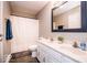 Bathroom featuring double sinks, a large framed mirror, and a shower with curtain at 12566 S Hillview Dr, Columbus, IN 47201