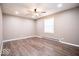 Empty bedroom featuring neutral walls, wood-look flooring, and a ceiling fan with lights at 12566 S Hillview Dr, Columbus, IN 47201