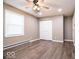 Bedroom featuring closet, window, neutral walls, wood-look flooring, and a ceiling fan at 12566 S Hillview Dr, Columbus, IN 47201