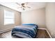 Bedroom featuring a bed, window, neutral walls, wood-look flooring, and a ceiling fan at 12566 S Hillview Dr, Columbus, IN 47201