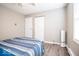 Bedroom featuring bed, closet, neutral walls, wood-look flooring, and a window at 12566 S Hillview Dr, Columbus, IN 47201