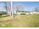 Single story home with light green exterior paint and small, but well maintained landscaping at 12566 S Hillview Dr, Columbus, IN 47201