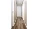 Hallway with modern flooring, neutral walls, and white doors and trim at 12566 S Hillview Dr, Columbus, IN 47201