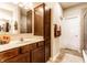 Bathroom with dark wood cabinets, white marble counter, and large mirror at 1371 Blackthorne N Trl, Plainfield, IN 46168