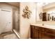 Bathroom featuring tile-surround shower with glass door and decorative floral wall art at 1371 Blackthorne N Trl, Plainfield, IN 46168
