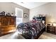 Well-lit bedroom with patterned bedding and wooden furniture at 1371 Blackthorne N Trl, Plainfield, IN 46168