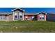 Exterior view of the home showcasing red shutters and well maintained lawn at 1371 Blackthorne N Trl, Plainfield, IN 46168