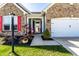 A well-kept home entrance with red shutters, potted plants, and a cozy porch, inviting you to experience the charm at 1371 Blackthorne N Trl, Plainfield, IN 46168