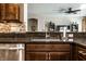 Close-up of a kitchen sink with granite countertops, stainless steel fixtures, and a mosaic backsplash at 1371 Blackthorne N Trl, Plainfield, IN 46168