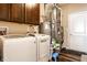 Laundry area features a washer, dryer, overhead cabinet, and utilities at 1371 Blackthorne N Trl, Plainfield, IN 46168