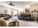 Spacious living room featuring plush seating, a ceiling fan, and abundant natural light, creating a cozy and inviting atmosphere at 1371 Blackthorne N Trl, Plainfield, IN 46168