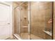 Tile-surround shower with glass door, built-in corner shelf, and shower head at 1371 Blackthorne N Trl, Plainfield, IN 46168